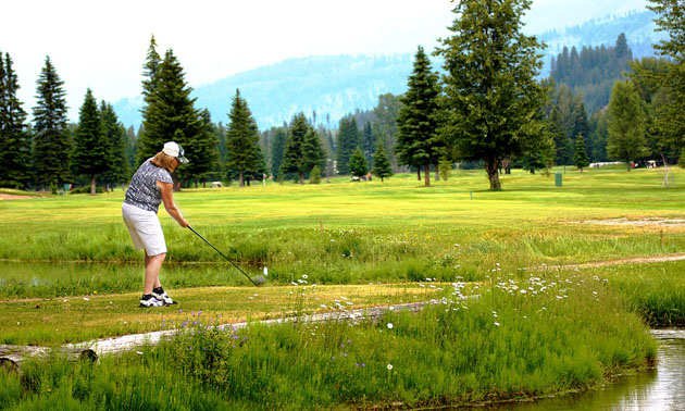 Person golfing at Mountain Meadows Golf Club. 