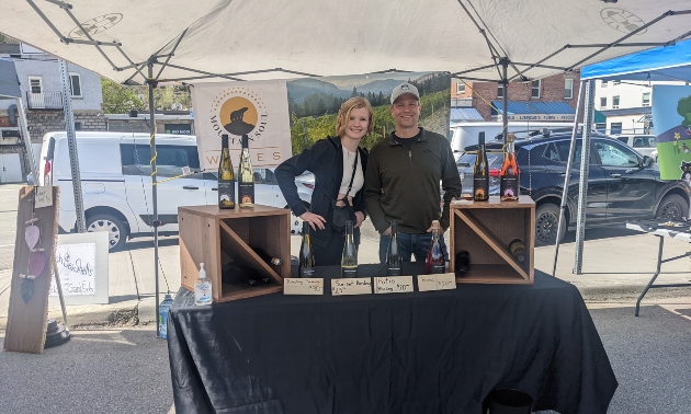 The owners of Mountain Soul Winery at a vending booth selling their wines