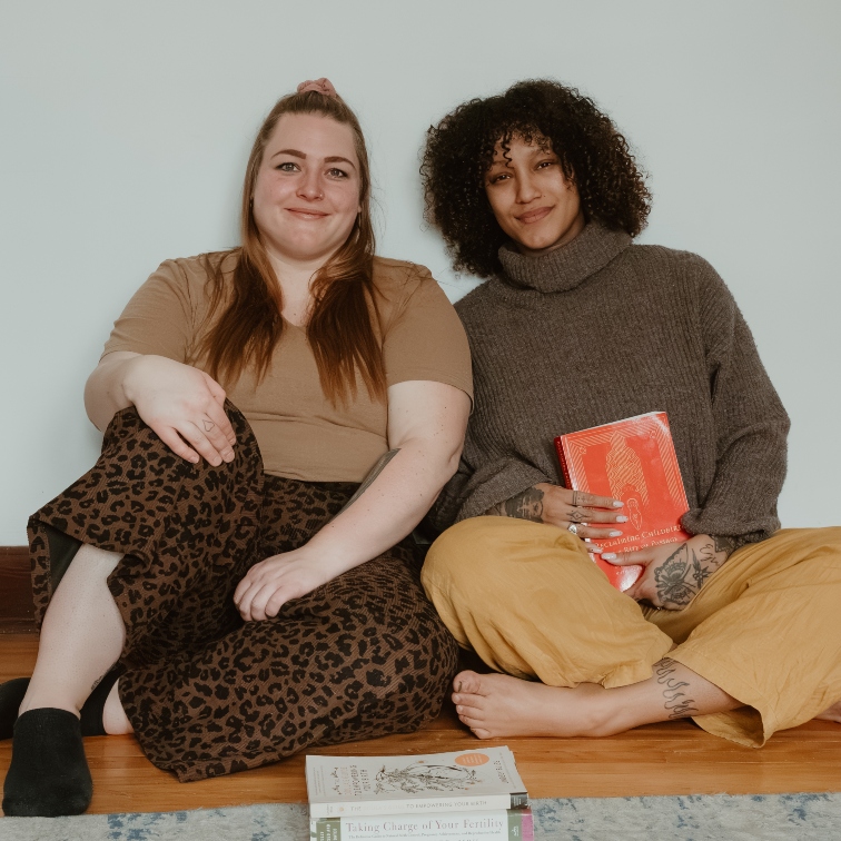 Mila and Shania sitting together on the floor