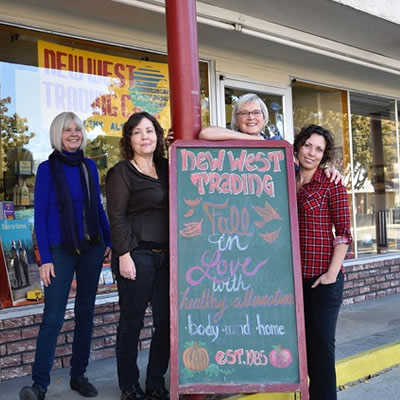 Connie Lawrence, owner of The New West Trading Co. 1985 in Grand Forks, is standing outside her store with three staff members.