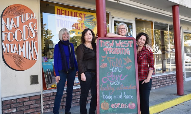 Connie Lawrence, owner of The New West Trading Co. 1985 in Grand Forks, is standing outside her store with three staff members.