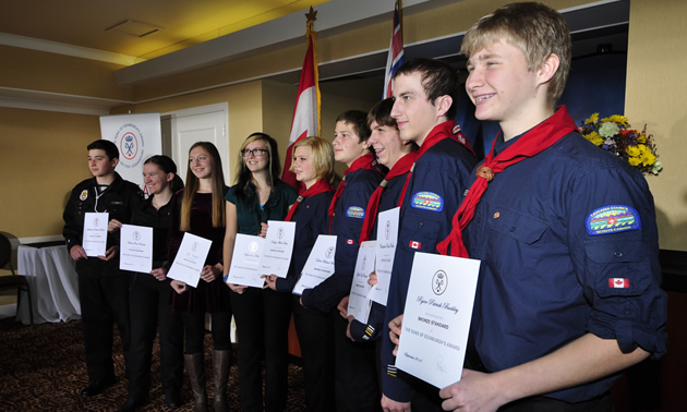 Nine youth holding their Duke of Edinburgh Award