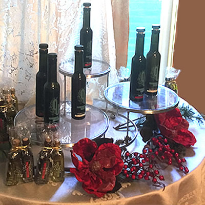 Picture of table with various bottles of olive oils on it. 