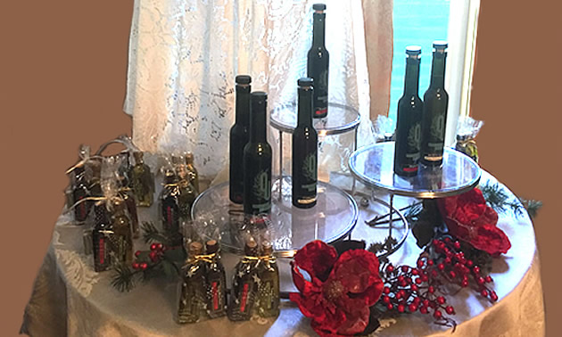 Picture of table with various bottles of olive oils on it. 
