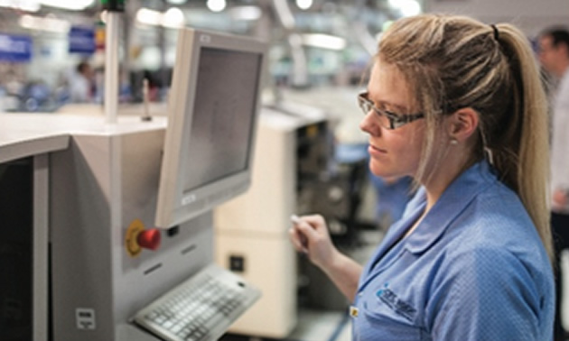 Picture of woman with blonde hair working on computer. 