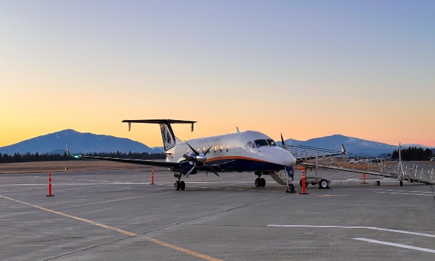 Plane on the runway as the sun goes down