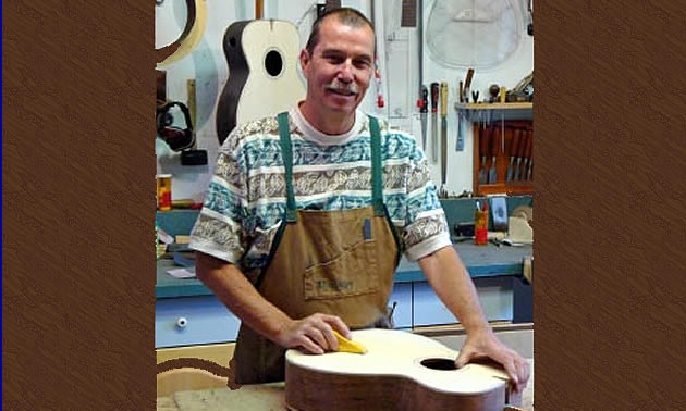 man making a guitar