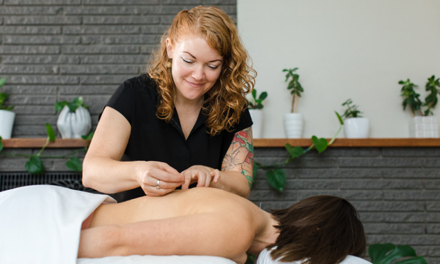 Julie doing acupuncture on one of her clients