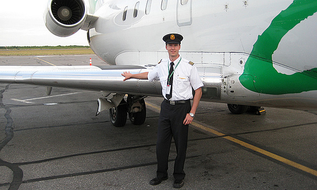 person standing beside an airplane