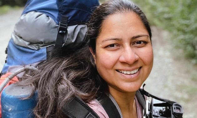 Priya hiking with a backpack on