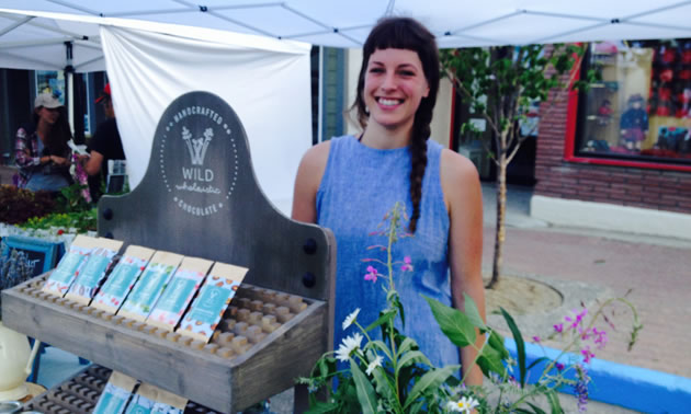 Janet Borger is standing at her booth at the Kimberley Farmers Market, selling her chocolate bars.