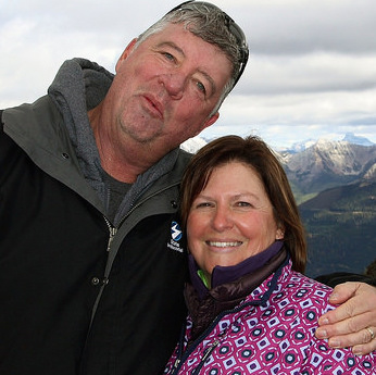 Rick and Lynn O'Neill with the snow covered Rocky Mountains in the background. 