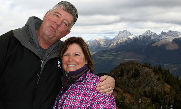 Rick and Lynn O'Neill with the snow covered Rocky Mountains in the background. 