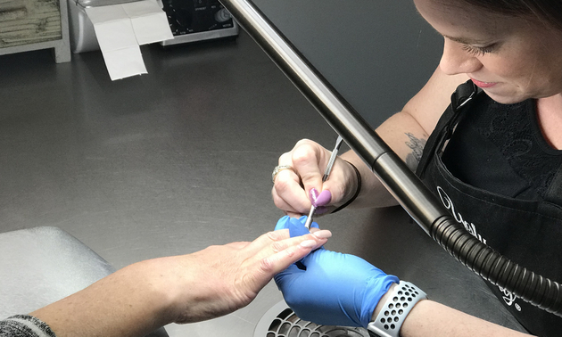 Sarah Fontaine doing a client's nails