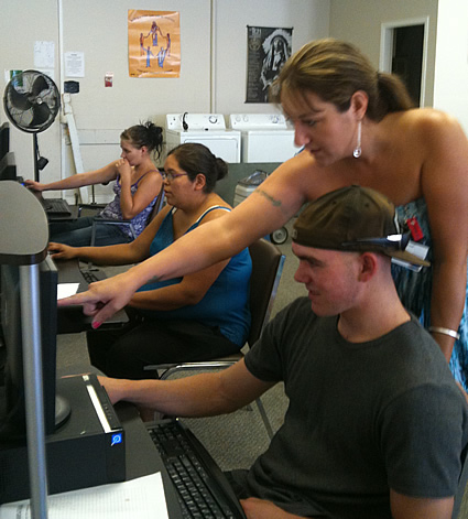 Photo of Wendy Bond helping youth with a focus program