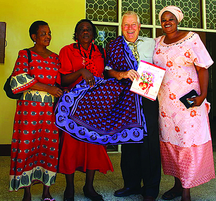 Instructional Officer Doug McLachlan is shown in a kanga (a traditional East African garment) with staff from Tanzaniaâ€™s Mineral Resources Institute.