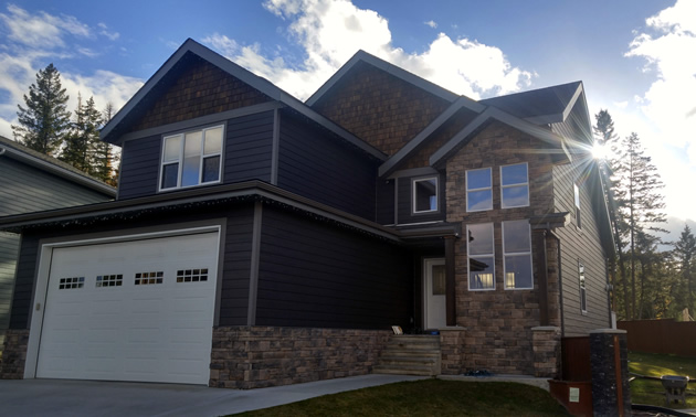 A Cranbrook home with engineered wood, cultured stone and cedar shakes. 