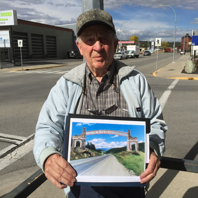 Picture of Skip Fennessy, holding picture of proposed Cranbrook arches. 