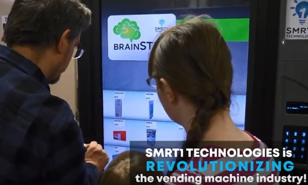 Girl and man using a Smart touch-based vending machine. 