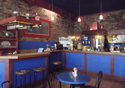 photo of the inside of a restaurant with blue tables. 