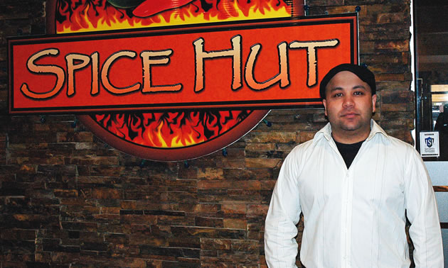 man standing in front of the Spice Hut in Cranbrook BC