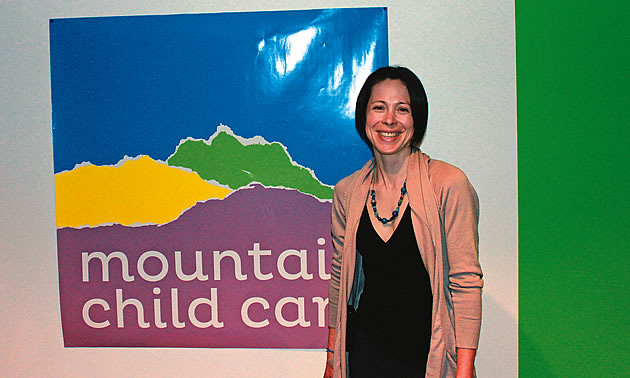 lady standing in front of a child care sign