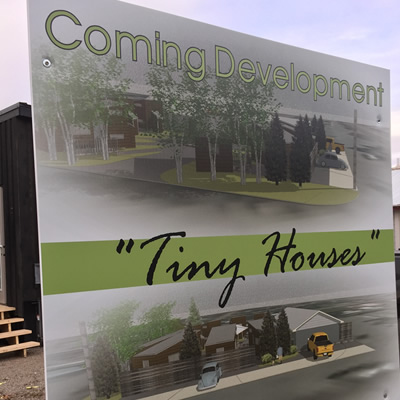 A billboard advertising the coming tiny home development. 