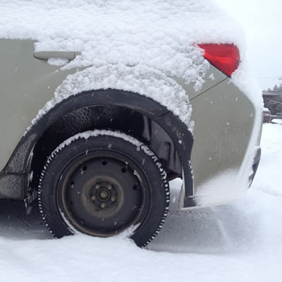 An Observe tire on a Subaru in the snow