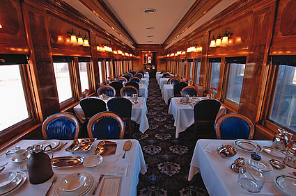 interior of a train car with dinner seating