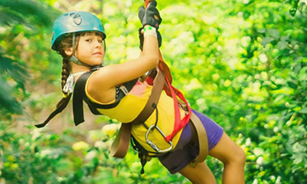 Photo of young girl on zipline. 