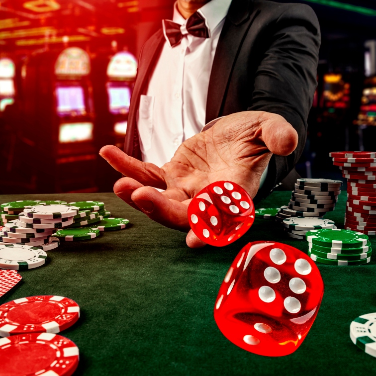 closeup of a hand rolling red and green dice at a casino