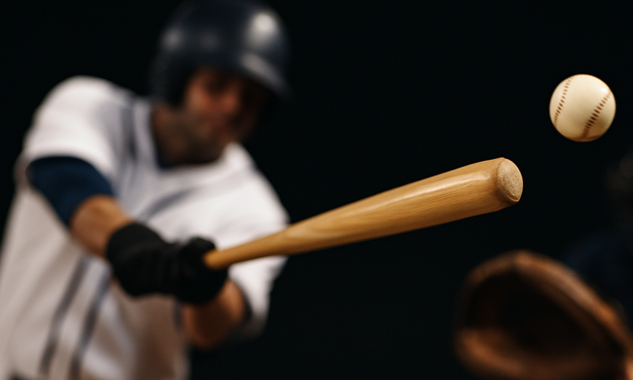 person swinging a baseball bat