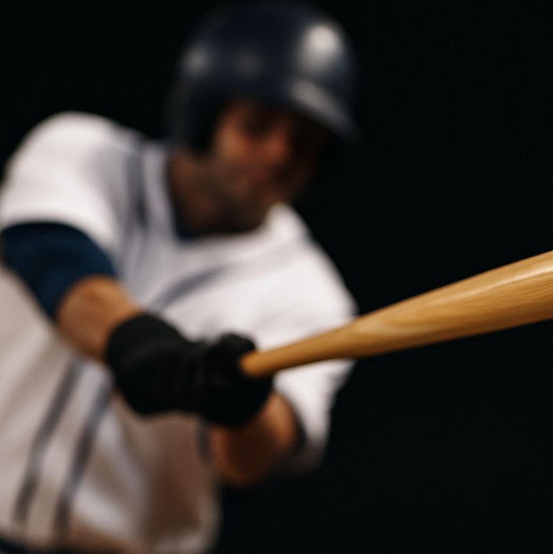 person swinging a baseball bat