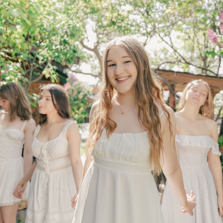 Nicole standing in the foreground with other young women standing behind her