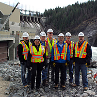 A group of officials standing in front of the Waneta Expansion Project. 