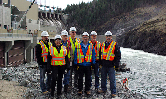 A group of officials standing in front of the Waneta Expansion Project. 