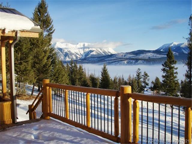 Looking off of the back deck on a fresh snowfall, with the sun sparkling on the snow and the mountains in the background. 