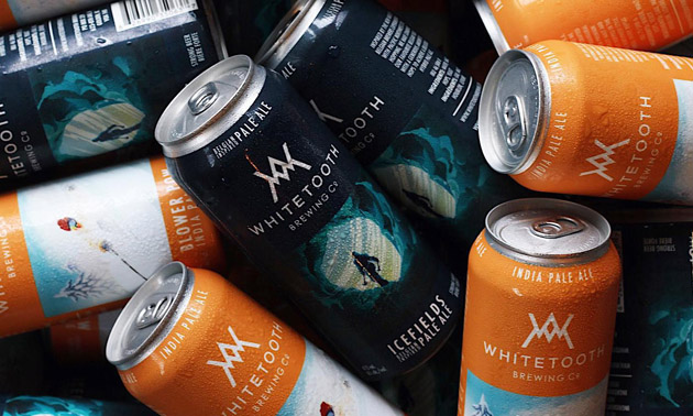 Close-up of Whitetooth Brewing Company cans. 