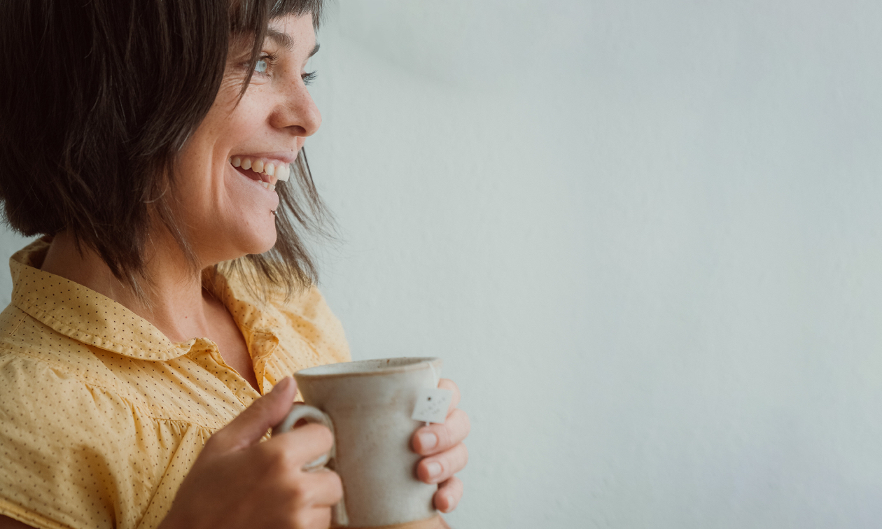 Andrea Legg, smiling and holding mug. 