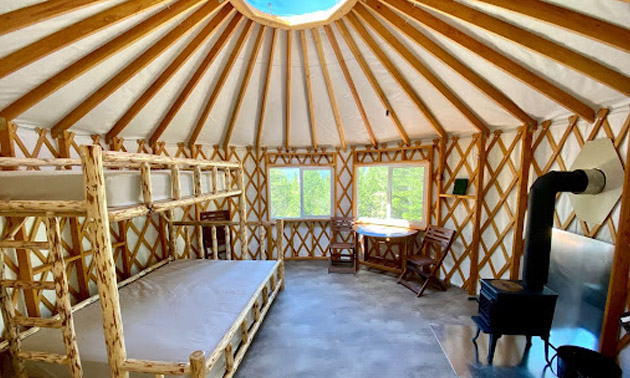 Inside of yurt showing bunk beds and woodstove. 