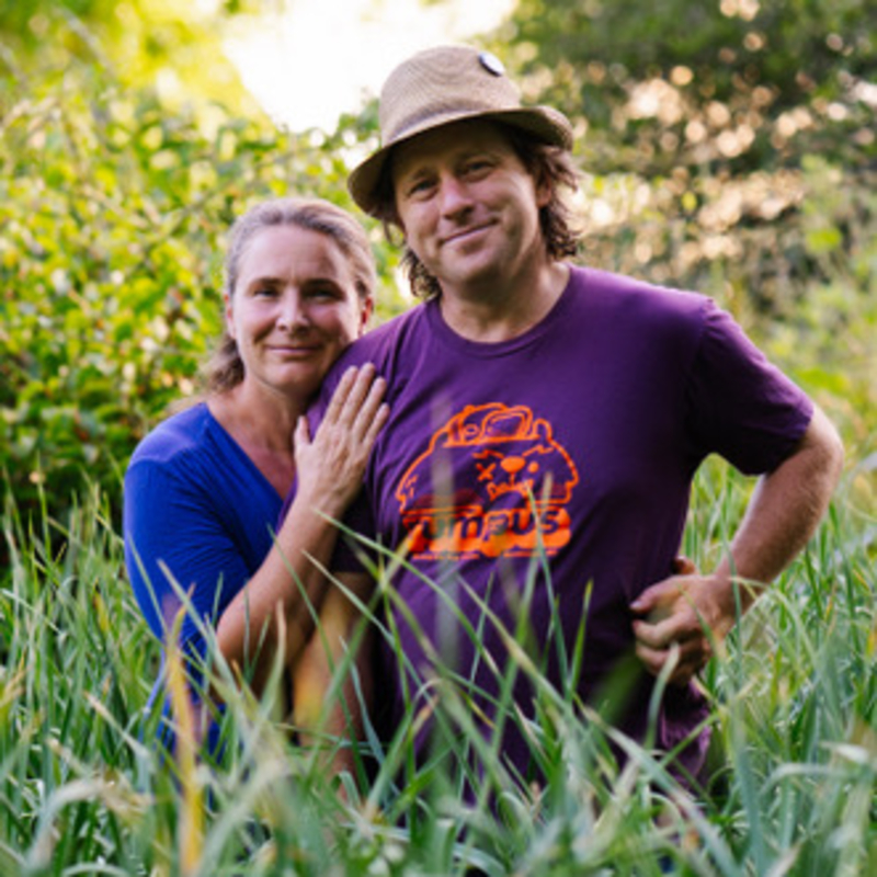 The owners of Track Street Growers standing in a field 